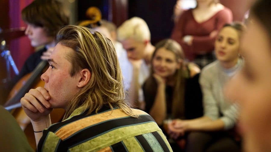 An audience member focuses on the music