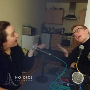 Georgia Affonso and Hugh Morris make a silly pose recording the No Dice podcast