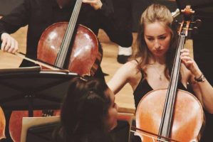 Anna Galloway playing cello for MUMS Orchestra